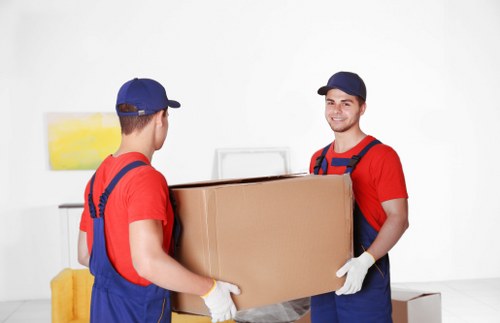 Packed boxes and furniture prepared for removal in a Kensington home